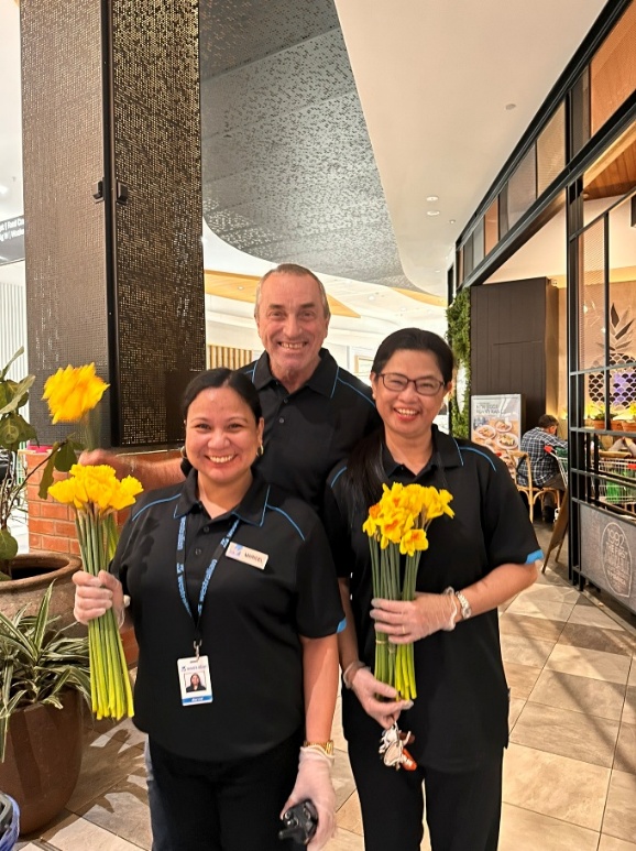Team members handing out daffodils on Daffodil Day
